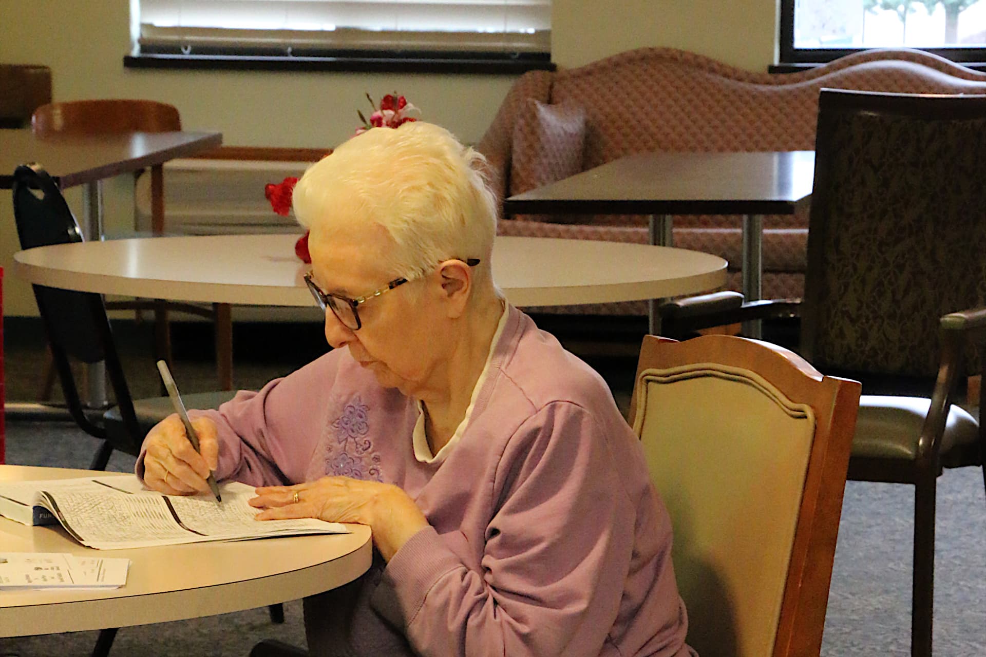 Senior woman working on crossword puzzle