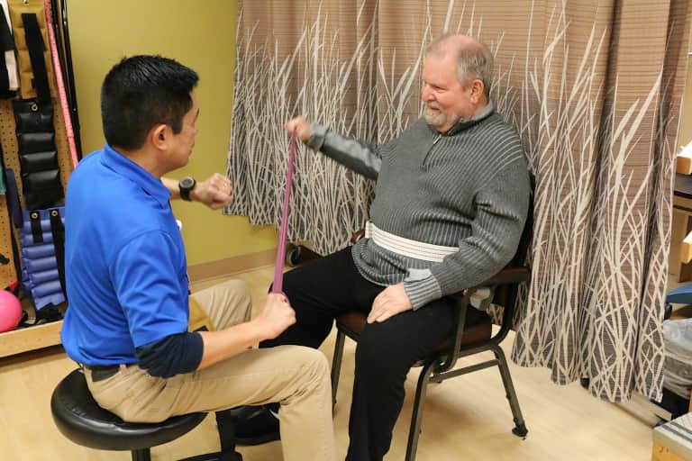 Senior man receiving physical therapy